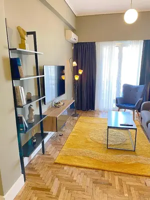 a living room with a couch and a table at Luxury Vacation by LV in Athens
