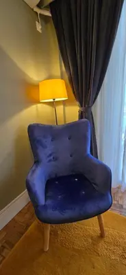 a blue chair sitting in a room with a lamp at Luxury Vacation by LV in Athens