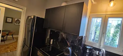 a kitchen with a black refrigerator and a window at Luxury Vacation by LV in Athens