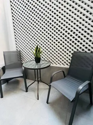 two chairs and a table with a potted plant on it at Likourgou Suite Dialog Number 1 VIPGreece in Athens