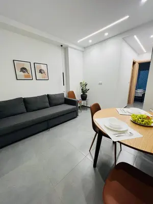 a living room with a couch and a table at Likourgou Suite Dialog Number 1 VIPGreece in Athens