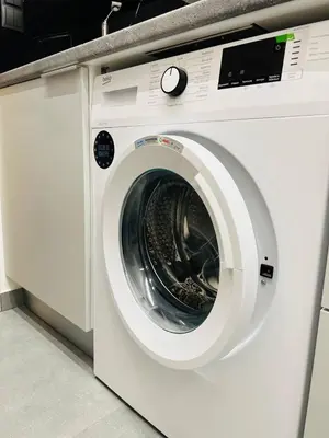 a white washing machine sitting in a room at Likourgou Suite Dialog Number 1 VIPGreece in Athens