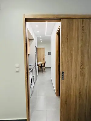 an open door to a kitchen with a table at Likourgou Suite Dialog Number 1 VIPGreece in Athens