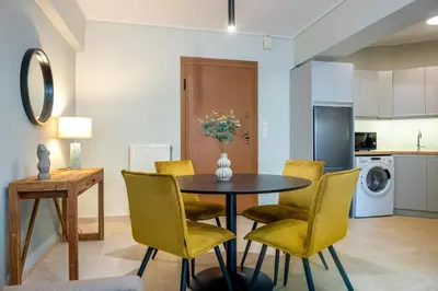 a kitchen and dining room with a table and chairs at Phaedrus Living Luxury Flat Ampelokipoi in Athens