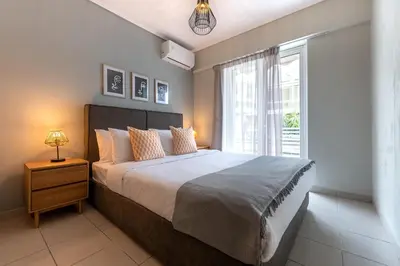 a bedroom with a large bed and a window at Phaedrus Living Luxury Flat Ampelokipoi in Athens