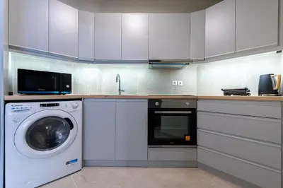 a kitchen with a washing machine and a washer at Phaedrus Living Luxury Flat Ampelokipoi in Athens