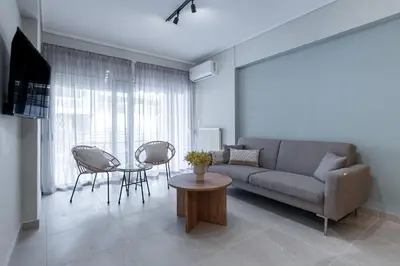 a living room with a couch and a table at Phaedrus Living Luxury Flat Ampelokipoi in Athens