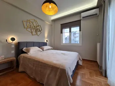 a bedroom with a bed and a window at Simple & Noble in Athens