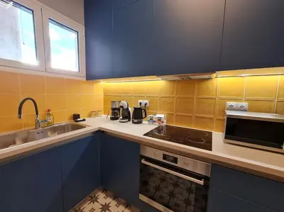 a kitchen with a sink and a stove top oven at Simple & Noble in Athens
