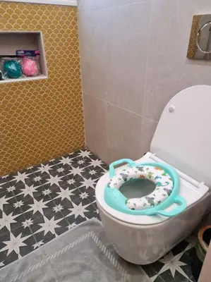 a bathroom with a toilet with a donut on the seat at Simple & Noble in Athens