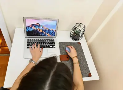 a woman sitting at a desk with a laptop computer at Georgia on my mind in Athens