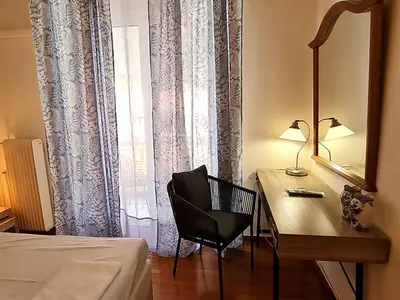 a bedroom with a desk and a chair next to a window at Georgia on my mind in Athens