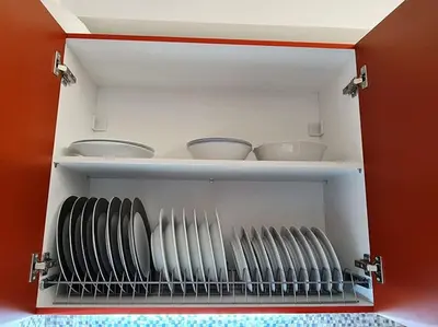 a cupboard with plates and bowls in it at Georgia on my mind in Athens