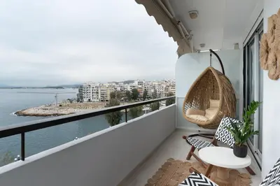 a balcony with a hammock and a view of the water at Blue Chill Paradise Seaview Suite w/ Kingbed in Piraeus