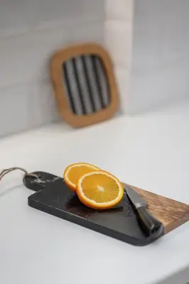 an orange slice on a cutting board with a knife at Blue Chill Paradise Seaview Suite w/ Kingbed in Piraeus