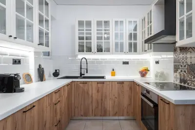 a white kitchen with wooden cabinets and a sink at Blue Chill Paradise Seaview Suite w/ Kingbed in Piraeus