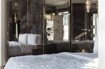 a bedroom with a bed with a large mirror at Luxury Acropolis View Apartment-Living Stone Black Pearl in Athens