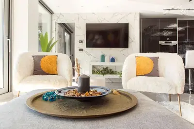 a living room with a table with a candle on it at Luxury Acropolis View Apartment-Living Stone Black Pearl in Athens
