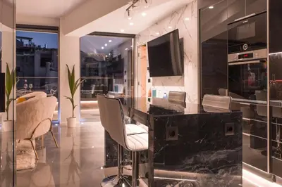 a dining room with a black marble table and chairs at Luxury Acropolis View Apartment-Living Stone Black Pearl in Athens