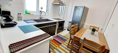 a kitchen with a table and a sink and a table and chairs at Thissio Central Onar in Athens