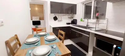 a small kitchen with a table and a sink at Thissio Central Onar in Athens