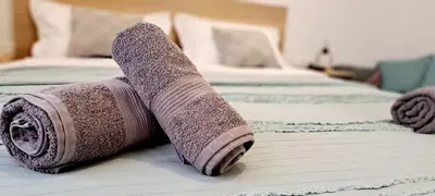 a rolled up towel on a bed in a hotel room at Thissio Central Onar in Athens