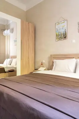 a bedroom with a large bed in a room at Cute full apt w/backyard in Paleo Faliro in Athens