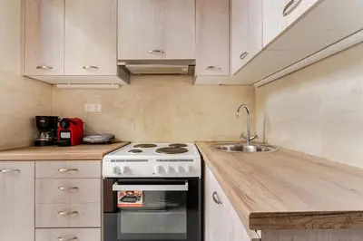 a kitchen with a stove and a sink at Cute full apt w/backyard in Paleo Faliro in Athens