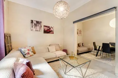 a living room with a couch and a table at Cute full apt w/backyard in Paleo Faliro in Athens