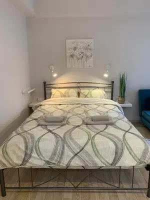 a bedroom with a bed with two bags on it at Marina Alkamenous apartment in Athens