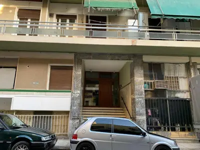a silver car parked in front of a building at Marina Alkamenous apartment in Athens