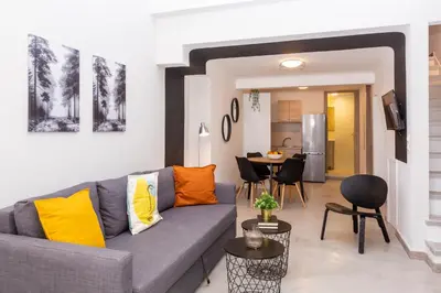 a living room with a couch and a table at Psirri Lofts in Athens