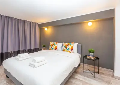 a bedroom with a large white bed in a room at Psirri Lofts in Athens