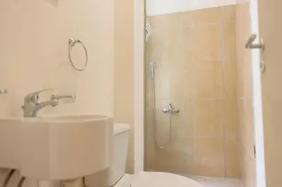 a bathroom with a shower and a toilet and a sink at ATHENS COMMERCIAL in Athens
