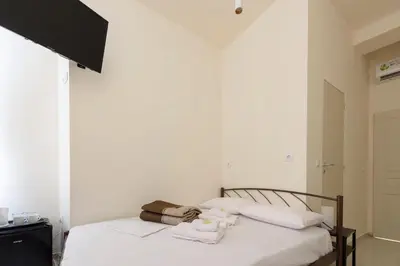 a bedroom with a bed with towels on it at ATHENS COMMERCIAL in Athens