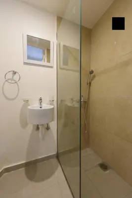 a bathroom with a sink and a glass shower at ATHENS COMMERCIAL in Athens