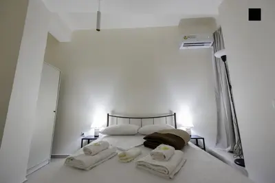 a bedroom with a bed with towels on it at ATHENS COMMERCIAL in Athens