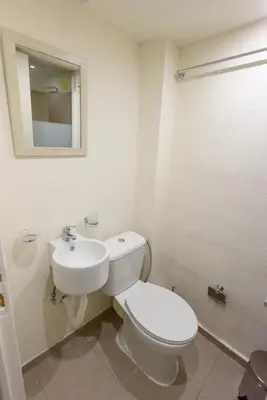 a bathroom with a white toilet and a sink at ATHENS COMMERCIAL in Athens