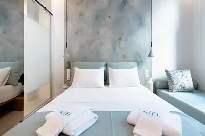 a bedroom with a bed with two towels on it at Ciel Suites Athens in Athens