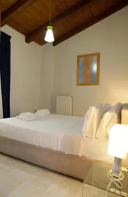 a bedroom with a large white bed in a room at Aθens Dome - Apartments by Live&Travel in Athens