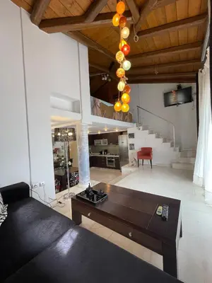 a living room with a couch and a table at Aθens Dome - Apartments by Live&Travel in Athens
