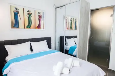 a bedroom with a bed with towels on it at Aθens Dome - Apartments by Live&Travel in Athens
