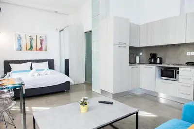 a bedroom with a bed and a kitchen with a table at Aθens Dome - Apartments by Live&Travel in Athens