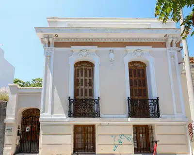 a white building with a balcony on top of it at Aθens Dome - Apartments by Live&Travel in Athens