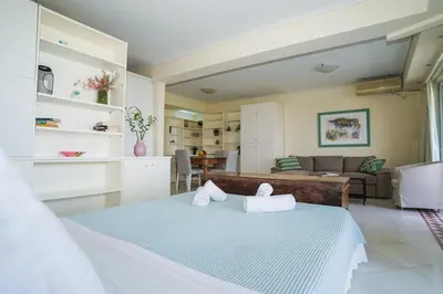 a bedroom with a bed and a living room at Endless Blue Studio in Glyfada in Athens