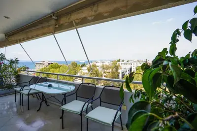 a balcony with chairs and a table and a view at Endless Blue Studio in Glyfada in Athens