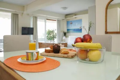 a table with a bowl of fruit and a bowl of oranges at Endless Blue Studio in Glyfada in Athens