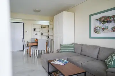 a living room with a couch and a table at Endless Blue Studio in Glyfada in Athens
