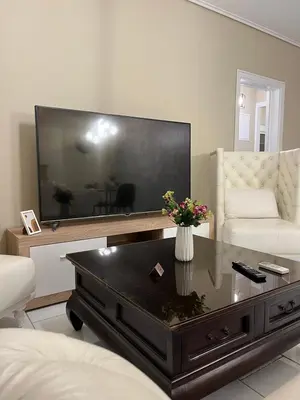a living room with a large flat screen tv at AIOLOS LUXURY alimos quiet SUITE 1 in Athens