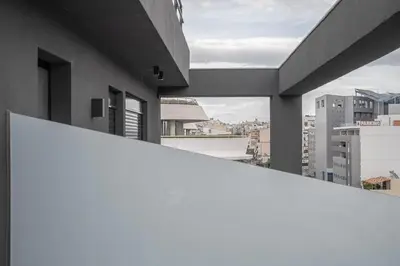 a view of a city from the balcony of a building at Μεζονέτα με θέα στο πάρκο Σταύρος Νιάρχος TWO in Athens